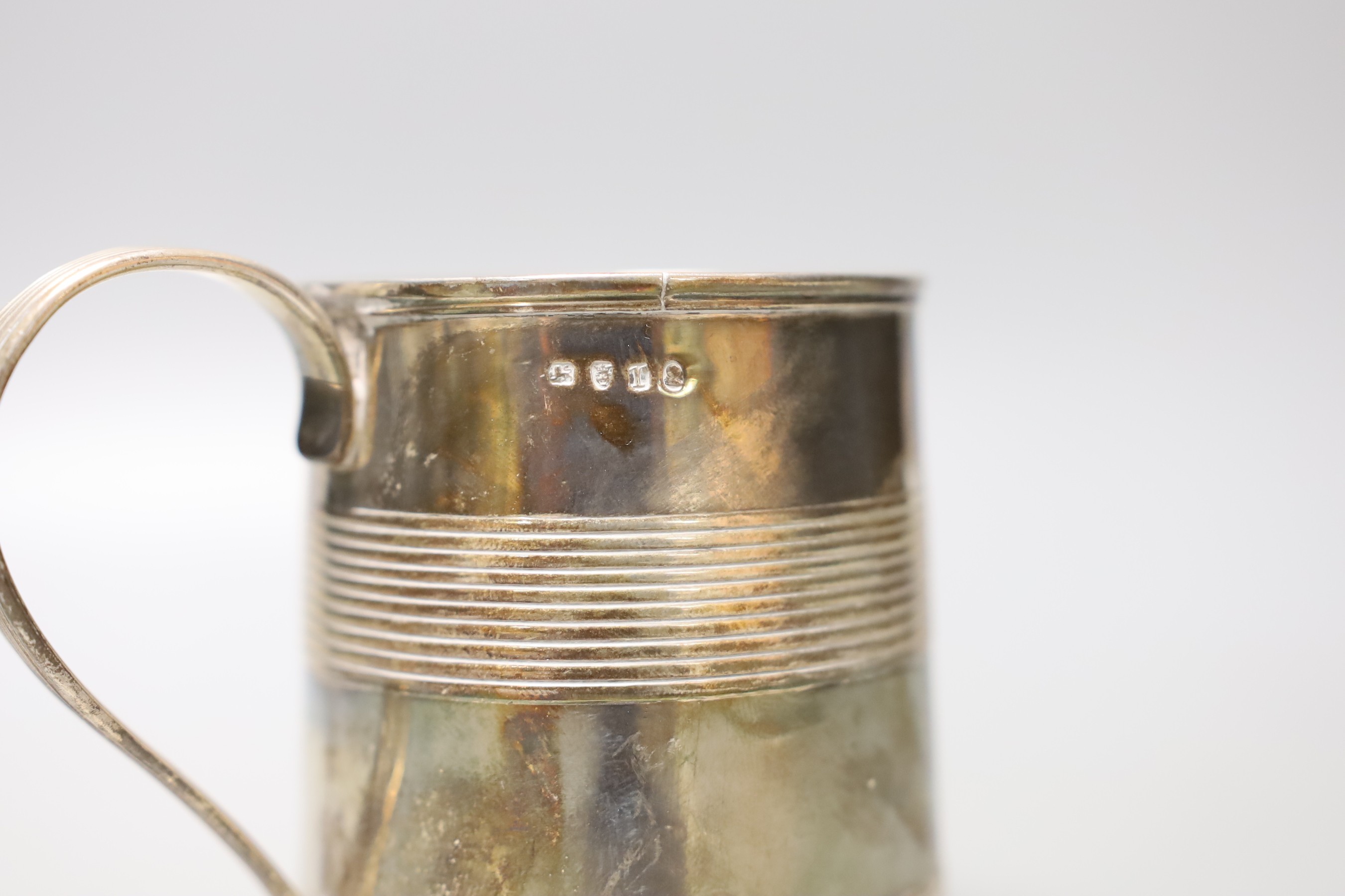 A George III silver mug, with two reeded bands and engraved inscription to the base, no maker's mark, London, 1801, 87mm, 203 grams.